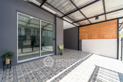 Modern covered patio with stylish tiles and sliding glass door