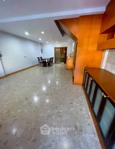 Spacious open-plan living area with elegant dining set and modern finishes.