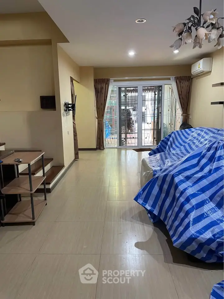 Spacious living room with modern decor and large windows for natural light.