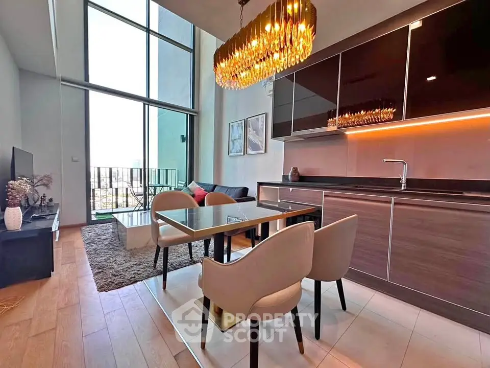 Luxurious modern living room with high ceilings and elegant chandelier in a stylish apartment.