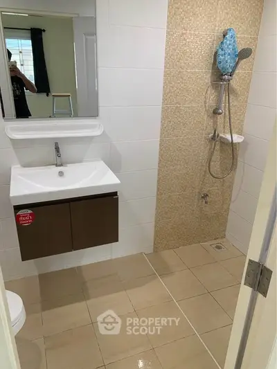 Modern bathroom with sleek fixtures and tiled shower area