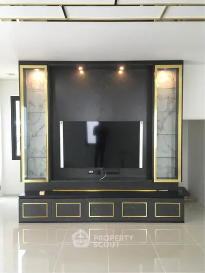 Luxurious modern living room with sleek TV wall unit and elegant marble accents