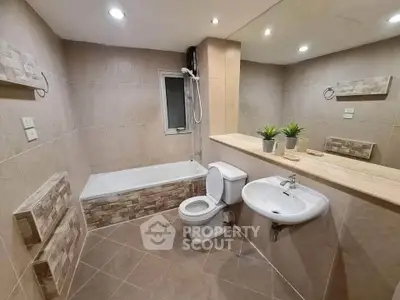 Modern bathroom with bathtub, sleek fixtures, and elegant tile design for a luxurious feel.