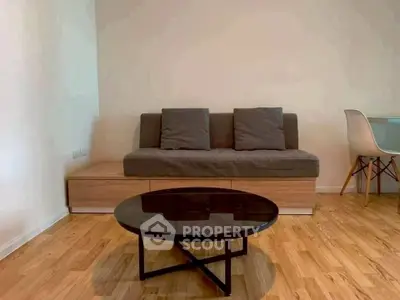 Modern living room with stylish sofa and sleek coffee table on wooden flooring.