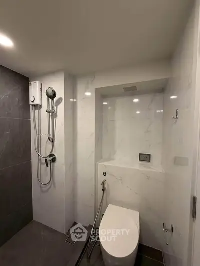 Modern bathroom with sleek shower and toilet in a minimalist design