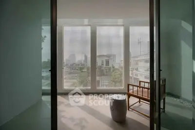 Serene balcony with city view and minimalist seating