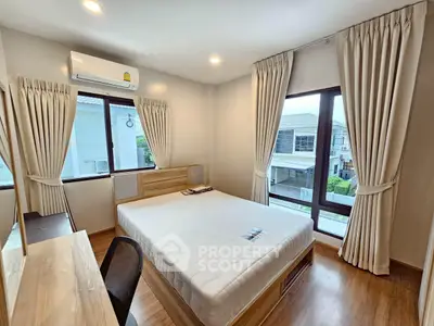 Bright and airy bedroom with large windows and modern furnishings