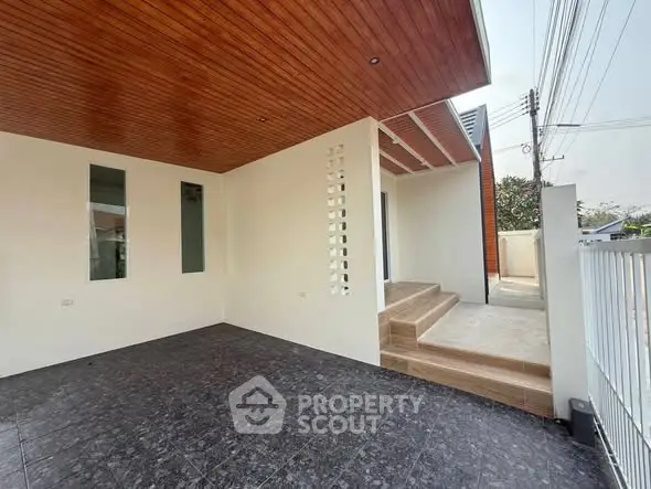 Modern home entrance with stylish wooden ceiling and tiled flooring