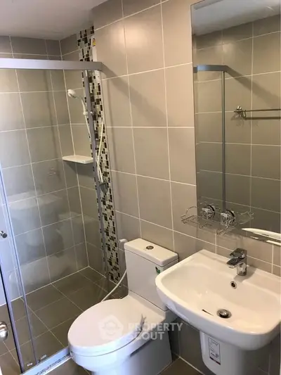 Modern bathroom with sleek shower and elegant fixtures in a contemporary apartment.