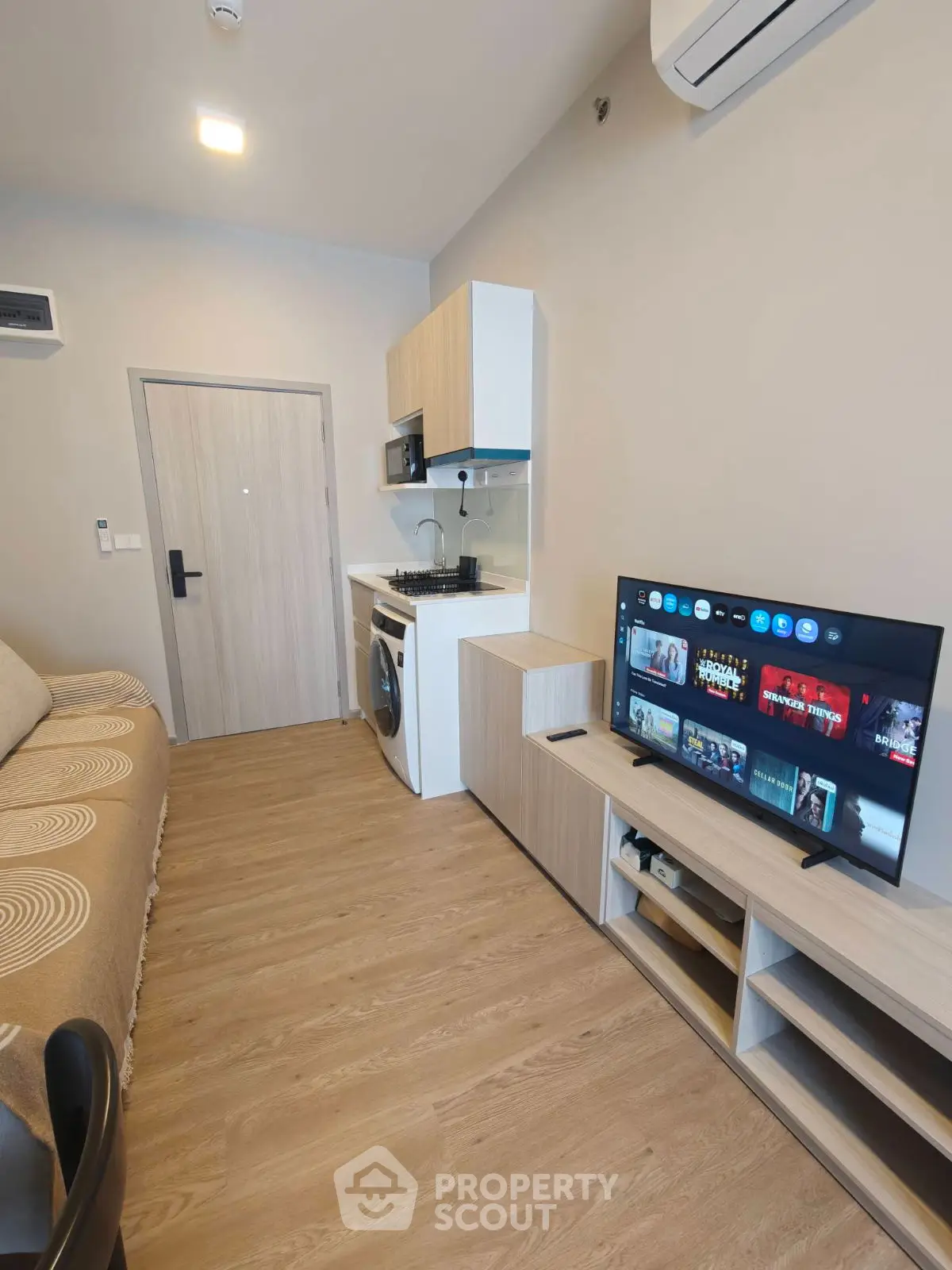 Modern compact living room with integrated kitchen and entertainment setup
