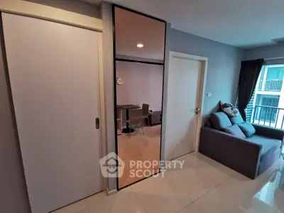 Modern living room with sleek design and cozy sofa, featuring a stylish dining area and balcony view.