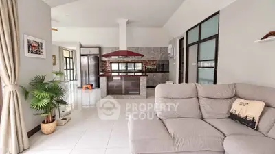 Spacious open-plan living room with modern kitchen and cozy sofa