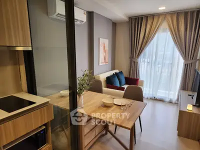 Modern living room with open kitchen and elegant decor in a cozy apartment.