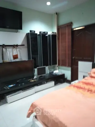 Cozy bedroom with modern decor and entertainment setup