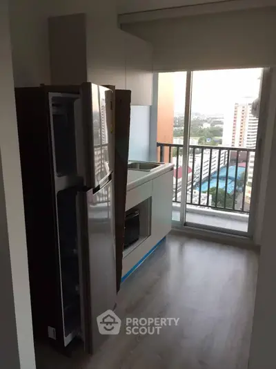 Modern kitchen with balcony view in high-rise apartment