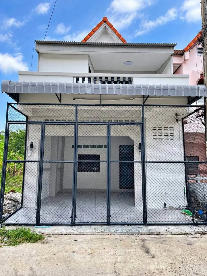 Charming two-story house with gated entrance and balcony, perfect for modern living in a serene neighborhood.