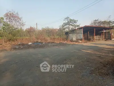 Spacious vacant land with rustic shed, ideal for development opportunities.