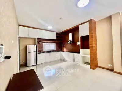 Spacious modern kitchen with sleek cabinetry and stainless steel appliances