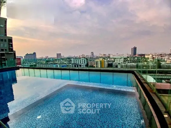 Stunning rooftop pool with panoramic city views at sunset