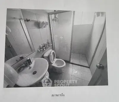 Cozy bathroom with shower and sink in a compact layout.