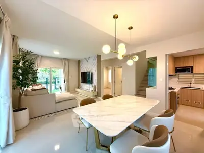Elegant open-plan living and dining area with modern decor and natural light.