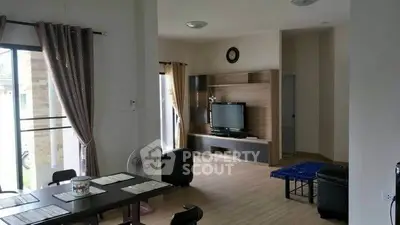 Spacious living room with modern decor and large windows for natural light.