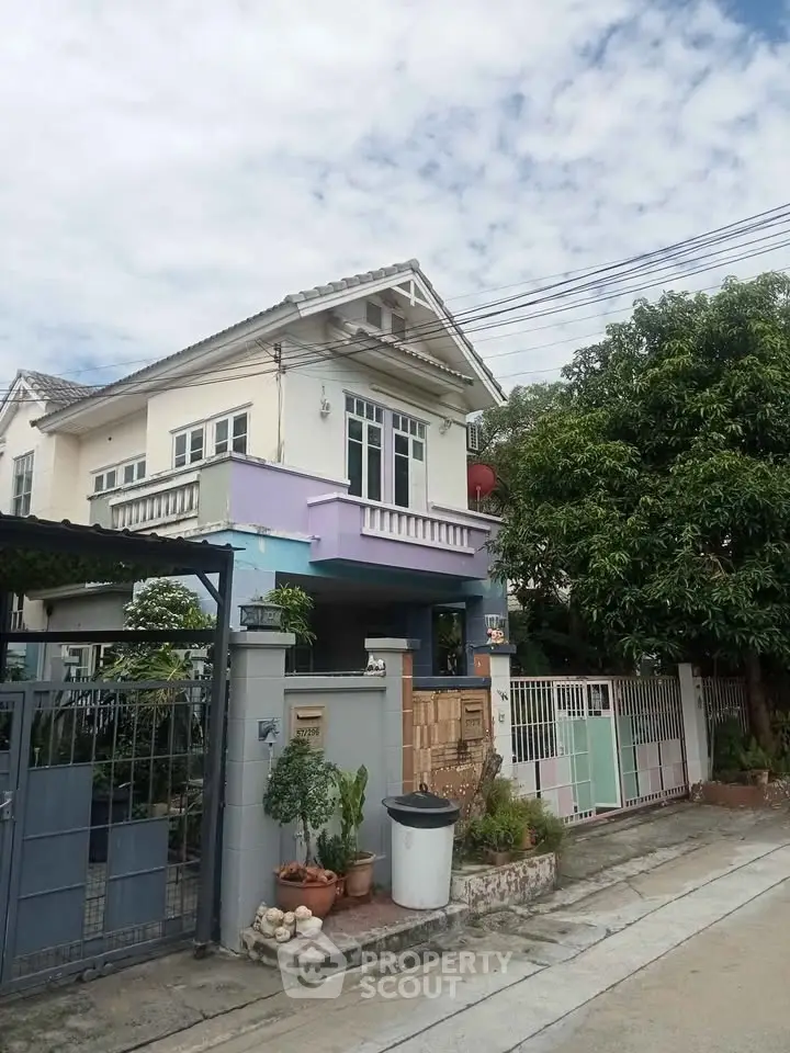 Charming two-story house with lush greenery and modern design in a serene neighborhood.