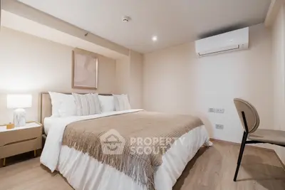 Modern bedroom with cozy decor and air conditioning in a stylish apartment.