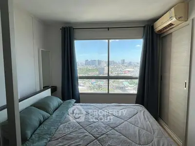 Modern bedroom with city view and air conditioning in high-rise apartment.