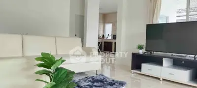 Modern living room with sleek furniture and open kitchen layout