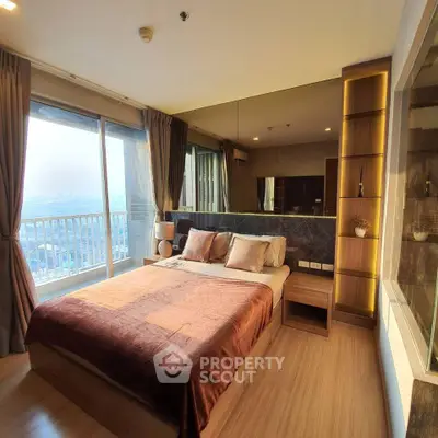 Luxurious bedroom with large windows and stunning city view, featuring elegant decor and ample natural light.