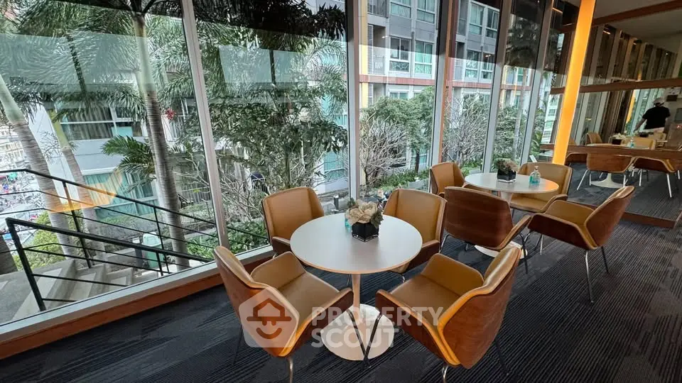 Modern co-working space with stylish seating and lush garden view
