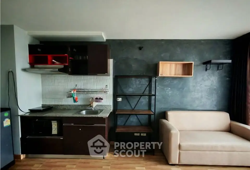 Modern studio apartment with sleek kitchen and cozy living area, perfect for urban living.