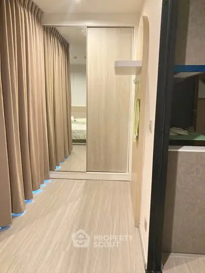 Modern bedroom with mirrored closet and elegant floor-to-ceiling curtains