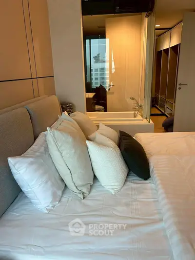 Luxurious bedroom with modern design and ensuite bathroom featuring a sleek bathtub.