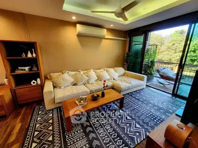 Stylish living room with cozy sofa, modern decor, and balcony view.