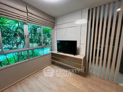 Modern living room with large windows and sleek TV setup