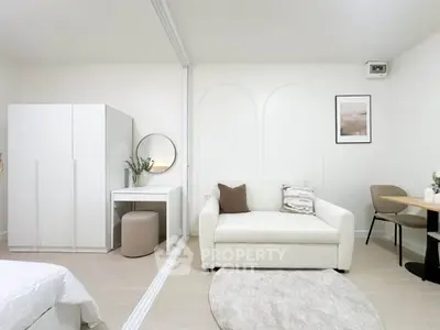 Modern studio apartment with stylish decor and cozy seating area