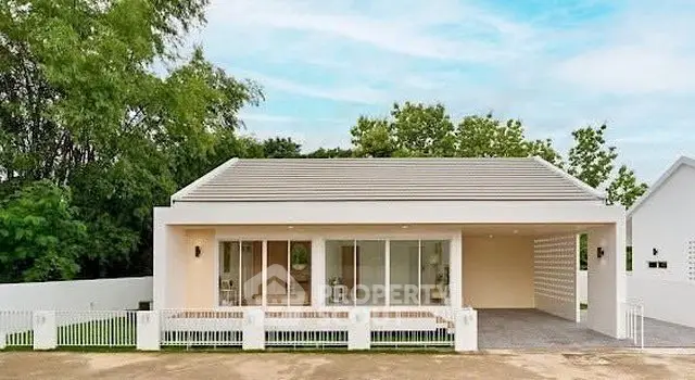 Modern single-story house with large windows and spacious driveway in a serene neighborhood.