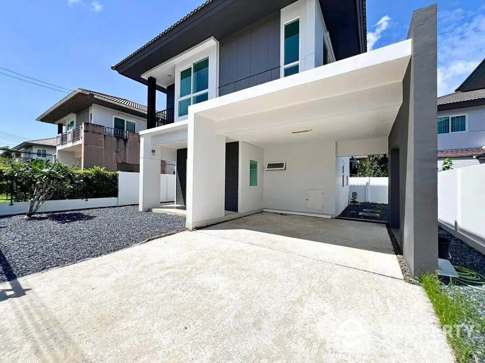 Modern two-story house with spacious driveway and sleek exterior design