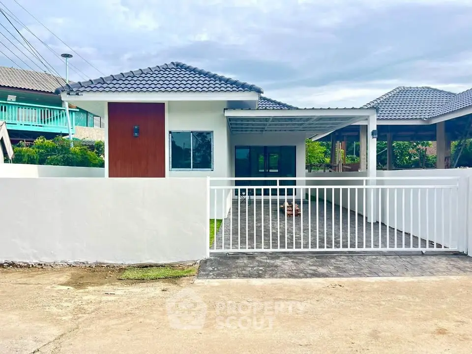 Charming single-story house with modern design and spacious driveway in a serene neighborhood.