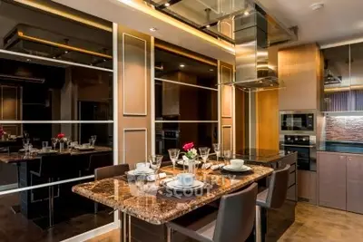 Luxurious modern kitchen with elegant dining setup and high-end appliances