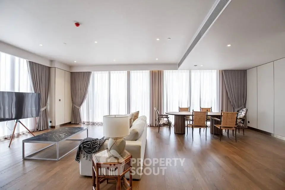 Spacious modern living room with elegant decor and large windows for natural light.