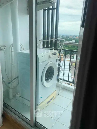 High-rise apartment balcony with washing machine and city view