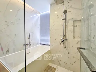 Luxurious modern bathroom with marble tiles and sleek shower design