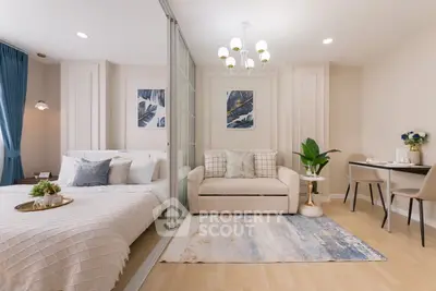 Elegant bedroom with cozy seating area and modern decor