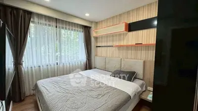 Cozy bedroom with large window and modern decor, perfect for relaxation.