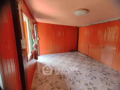 Vibrant orange room with patterned tile flooring and window view.