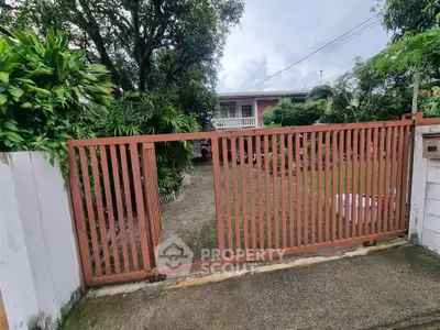 Charming suburban home with lush garden and gated entrance, perfect for family living.
