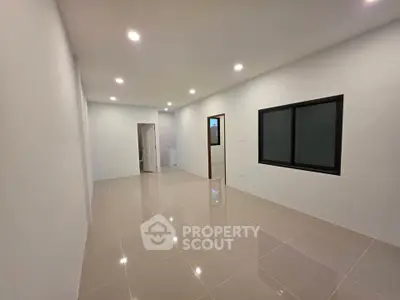 Spacious modern living room with sleek tile flooring and recessed lighting
